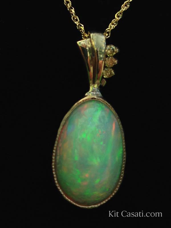 Ethiopian opal pendant with yellow diamonds, in 14k yellow gold. By Kit Casati.